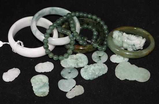 A quantity of jadeite items including bangles, a necklace and carvings.